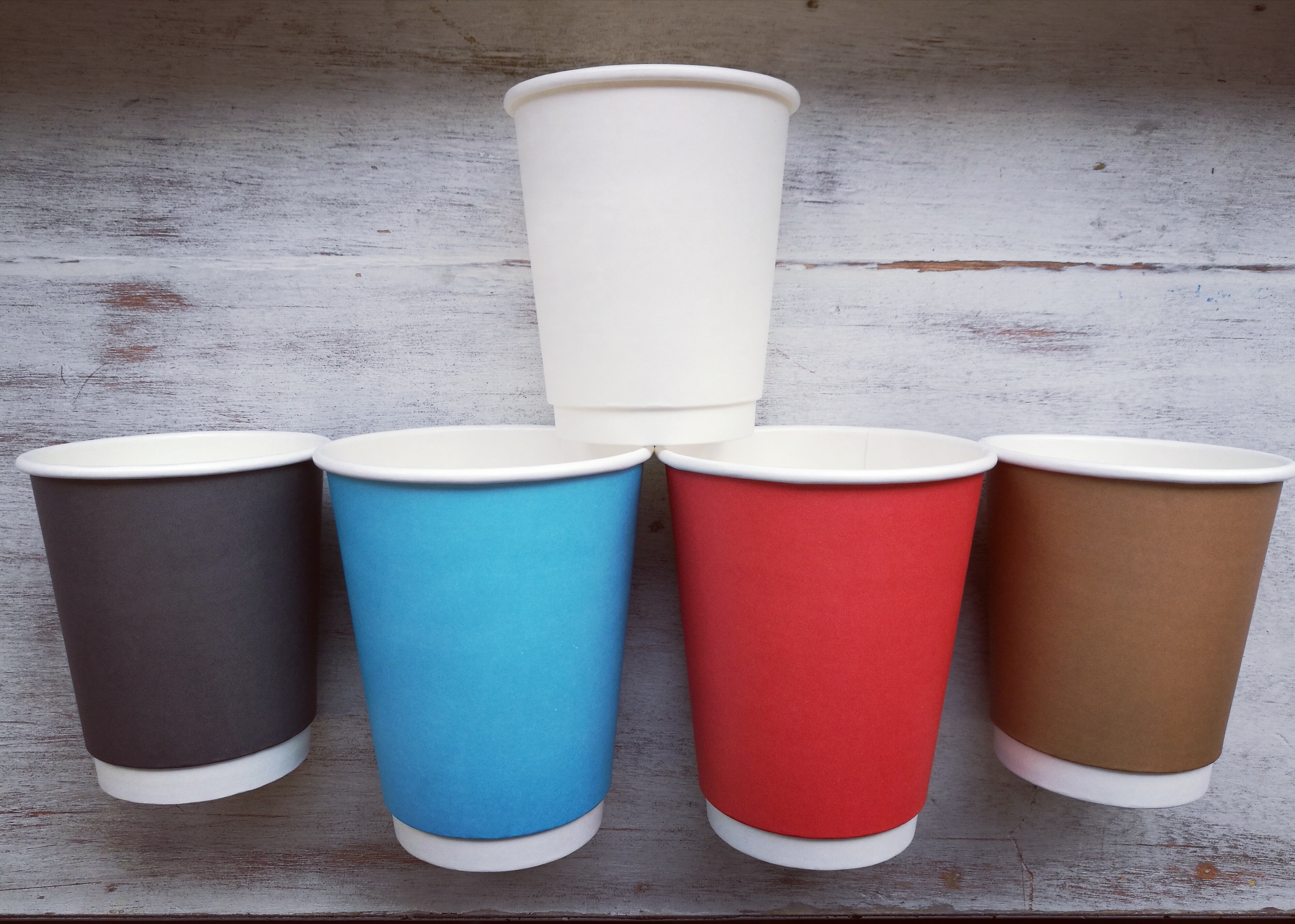 Takeaway paper coffee cups with coloured sleeves